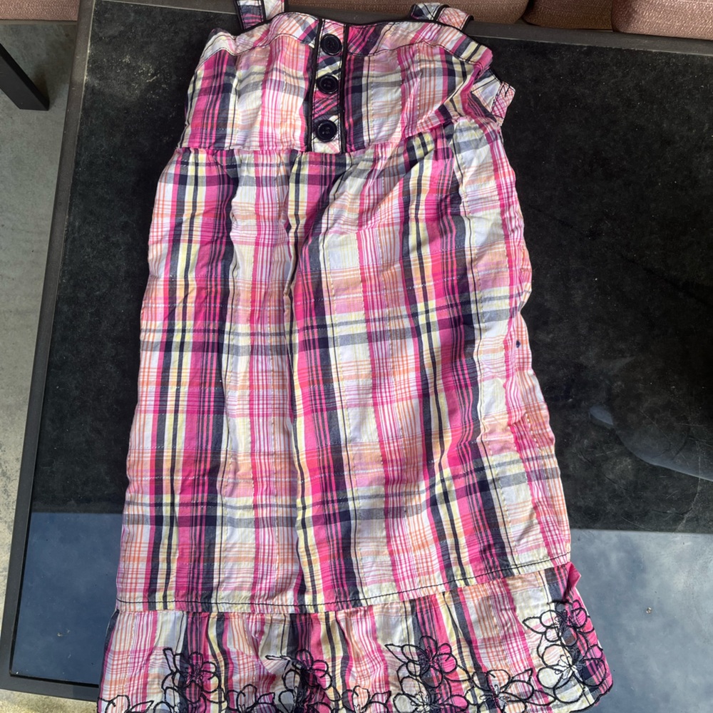 Pink dress with embroidered flowers at the bottom